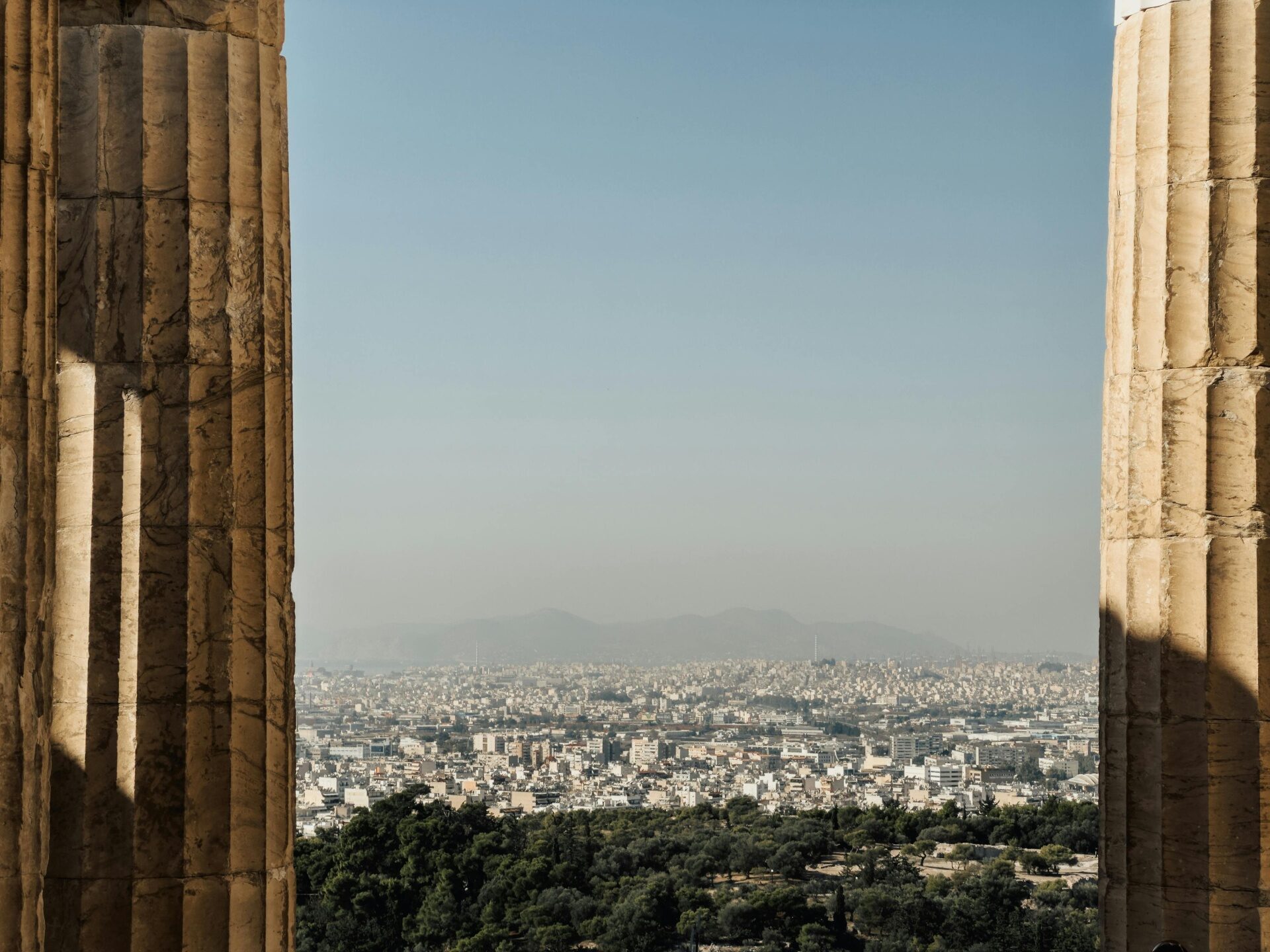 Ancient marble columns framing the Athens cityscape